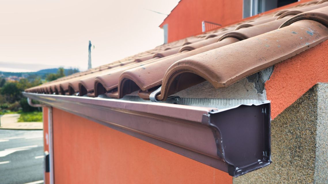 Clay tile roof edge with new gutter